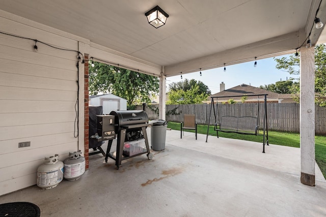 2775 Sweetbriar Ln, Grand Prairie, TX 75052 - view of patio featuring a fenced backyard, a shed, an outbuilding, and a grill