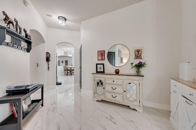 2775 Sweetbriar Ln, Grand Prairie, TX 75052 - corridor featuring arched walkways, light marble finish floors, and baseboards