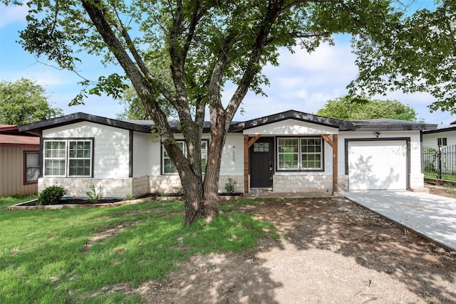 4320 Carmel Ave, Fort Worth, TX 76119 - ranch-style house with driveway, an attached garage, and stone siding