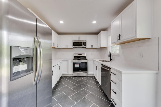 4320 Carmel Ave, Fort Worth, TX 76119 - kitchen featuring stainless steel appliances, a sink, decorative backsplash, light countertops, and white cabinets