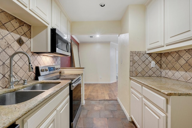 18333 Roehampton Dr Unit 714, Dallas, TX 75252 - kitchen with stainless steel appliances, a sink, tasteful backsplash, baseboards, and light stone countertops