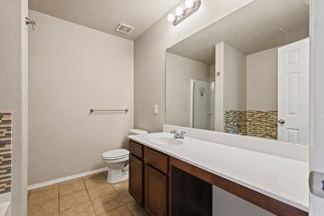 2352 Clairborne Dr, Fort Worth, TX 76177 - full bathroom featuring a shower, toilet, vanity, tile patterned floors, and baseboards