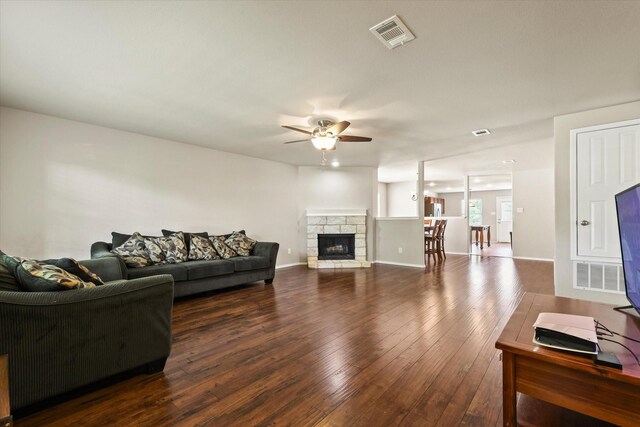 2352 Clairborne Dr, Fort Worth, TX 76177 - living room with ceiling fan, wood-type flooring, a stone fireplace, and baseboards