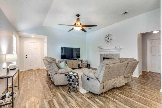 14320 Polo Ranch St, Fort Worth, TX 76052 - living area featuring light wood-style floors, a fireplace, ceiling fan, lofted ceiling, and baseboards