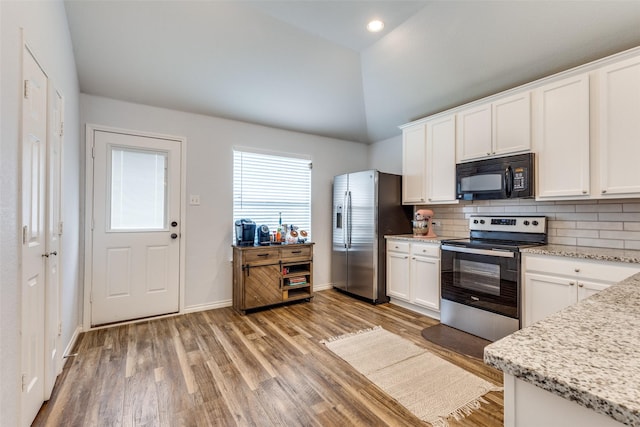 14320 Polo Ranch St, Fort Worth, TX 76052 - kitchen featuring appliances with stainless steel finishes, light wood-style floors, white cabinetry, tasteful backsplash, and high vaulted ceiling