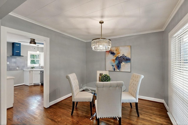 6042 Belgrade Ave, Dallas, TX 75227 - dining room featuring dark wood finished floors, a chandelier, ornamental molding, and baseboards
