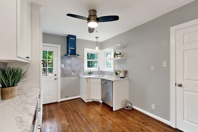 6042 Belgrade Ave, Dallas, TX 75227 - kitchen with stainless steel dishwasher, wall chimney exhaust hood, white cabinets, a ceiling fan, and dark wood finished floors