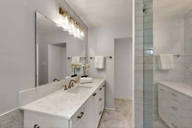 6042 Belgrade Ave, Dallas, TX 75227 - full bath featuring marble look tile flooring, vanity, and baseboards