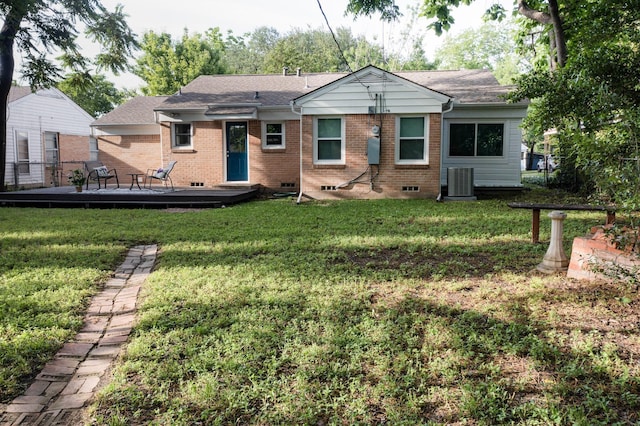 6042 Belgrade Ave, Dallas, TX 75227 - view of front facade featuring a wooden deck, a front yard, brick siding, and central AC unit