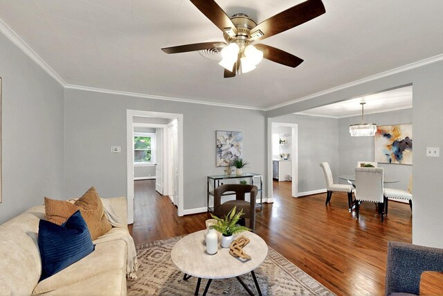 6042 Belgrade Ave, Dallas, TX 75227 - living room with crown molding, dark wood-style floors, baseboards, and a ceiling fan