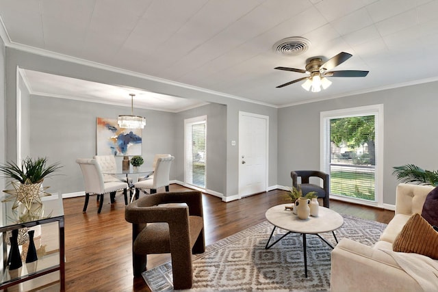 6042 Belgrade Ave, Dallas, TX 75227 - living room with dark wood-type flooring, baseboards, crown molding, ceiling fan, and a chandelier
