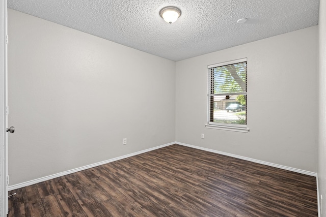 1530 Lime Leaf Ln, Duncanville, TX 75137 - spare room featuring dark wood-style flooring, baseboards, and a textured ceiling