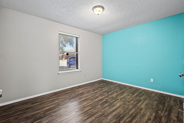 1530 Lime Leaf Ln, Duncanville, TX 75137 - unfurnished room featuring dark wood-style floors, a textured ceiling, and baseboards