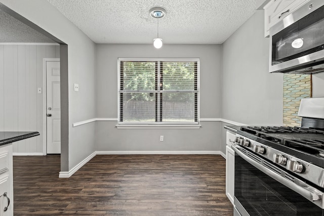 1530 Lime Leaf Ln, Duncanville, TX 75137 - kitchen featuring appliances with stainless steel finishes, dark wood-type flooring, a textured ceiling, and white cabinets