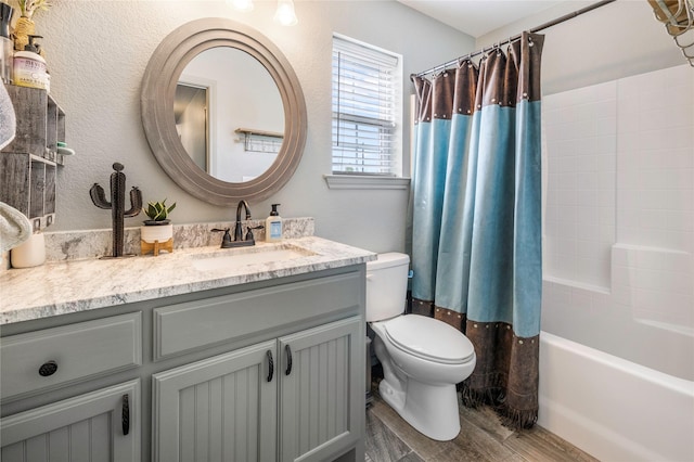 1668 Poe Prairie Rd, Millsap, TX 76066 - full bathroom with toilet, wood finished floors, vanity, and shower / bath combo