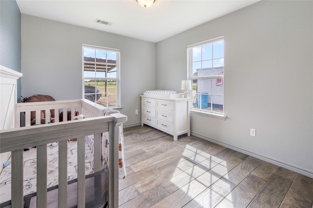 1668 Poe Prairie Rd, Millsap, TX 76066 - bedroom with a nursery area and light wood-type flooring
