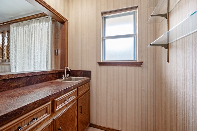bathroom featuring vanity and wallpapered walls