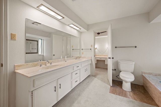 bathroom featuring toilet and double vanity