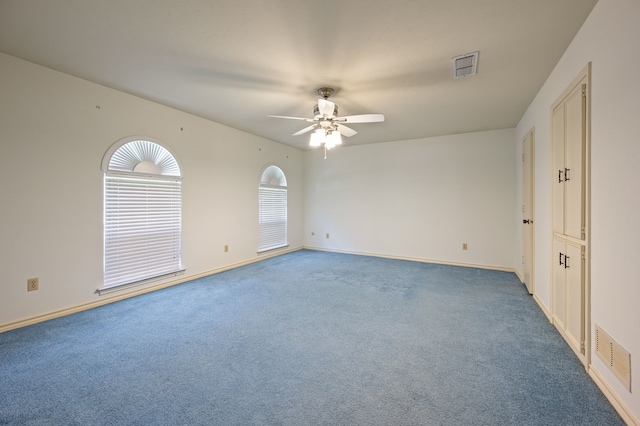 unfurnished room featuring ceiling fan, carpet floors, and baseboards