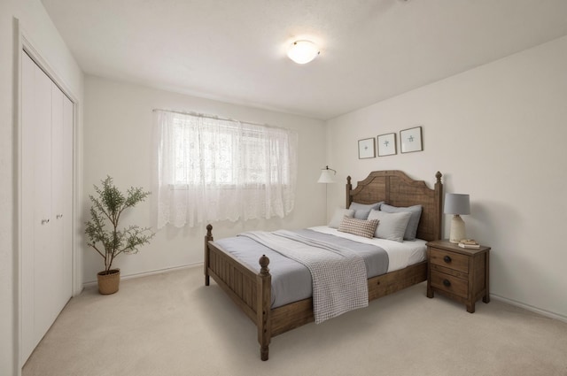 bedroom featuring light carpet and a closet