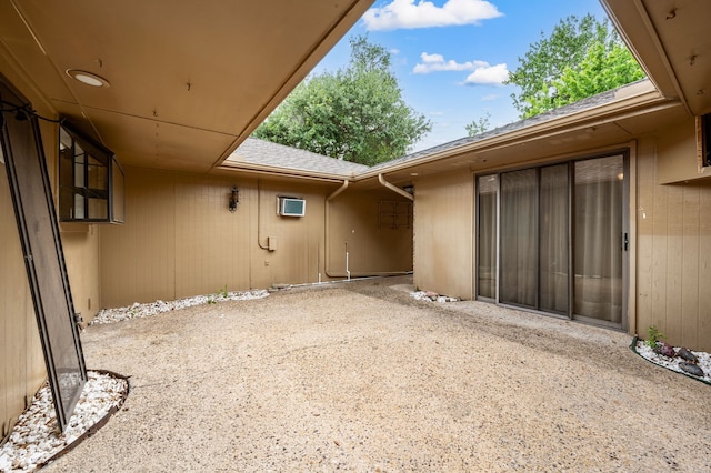 view of patio featuring a wall unit AC