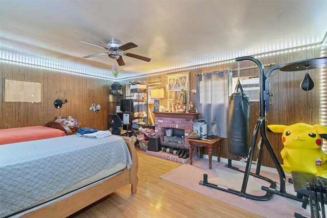 12015 Galva Dr, Dallas, TX 75243 - bedroom featuring wood finished floors, wooden walls, and a fireplace