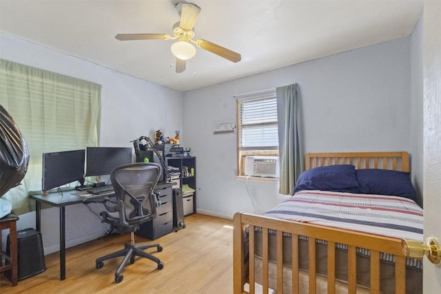 12015 Galva Dr, Dallas, TX 75243 - bedroom featuring cooling unit, wood finished floors, an office area, and a ceiling fan