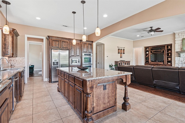 801 Shadow Hill Dr, Prosper, TX 75078 - kitchen with built in appliances, arched walkways, a sink, ceiling fan, and light tile patterned flooring