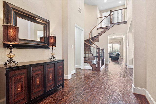 801 Shadow Hill Dr, Prosper, TX 75078 - foyer featuring arched walkways, stairs, baseboards, dark wood finished floors, and a towering ceiling