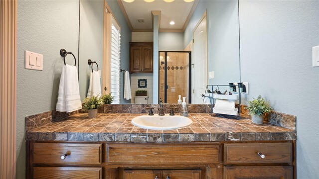 12046 Erin Ln, Fort Worth, TX 76179 - bathroom with a stall shower, a textured wall, crown molding, and vanity