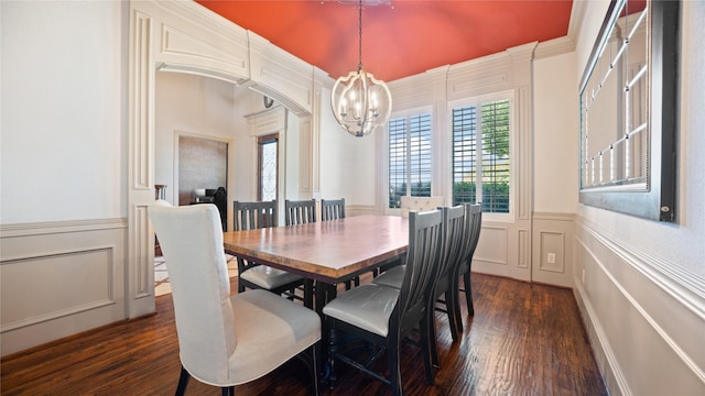 12046 Erin Ln, Fort Worth, TX 76179 - dining space featuring a chandelier, a decorative wall, a wainscoted wall, dark wood-style flooring, and arched walkways