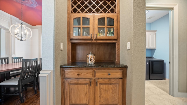 12046 Erin Ln, Fort Worth, TX 76179 - bar area with washer / clothes dryer, a chandelier, a textured wall, hanging light fixtures, and light tile patterned flooring