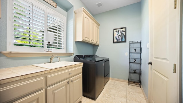 12046 Erin Ln, Fort Worth, TX 76179 - laundry area with cabinet space, washing machine and dryer, light tile patterned floors, and baseboards