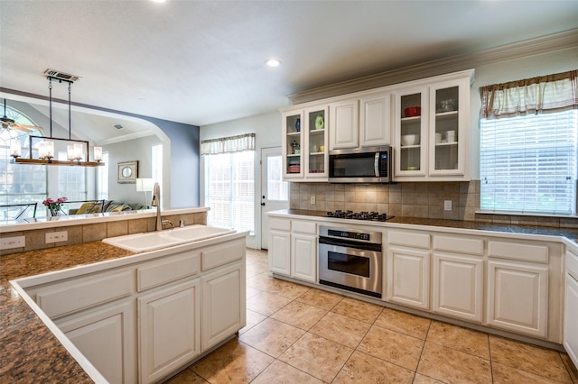 1414 Tulane Ct, Allen, TX 75013 - kitchen with appliances with stainless steel finishes, a sink, healthy amount of natural light, crown molding, and decorative backsplash