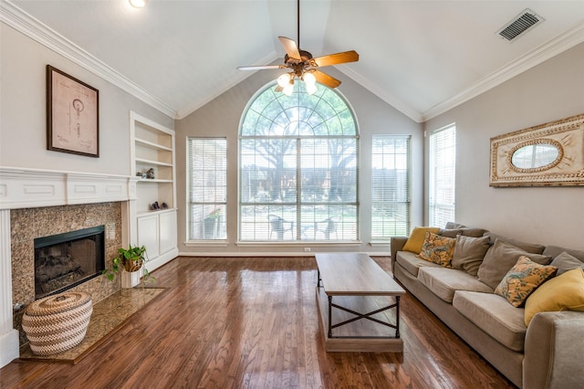 1414 Tulane Ct, Allen, TX 75013 - living room with a ceiling fan, built in shelves, wood finished floors, a tile fireplace, and vaulted ceiling