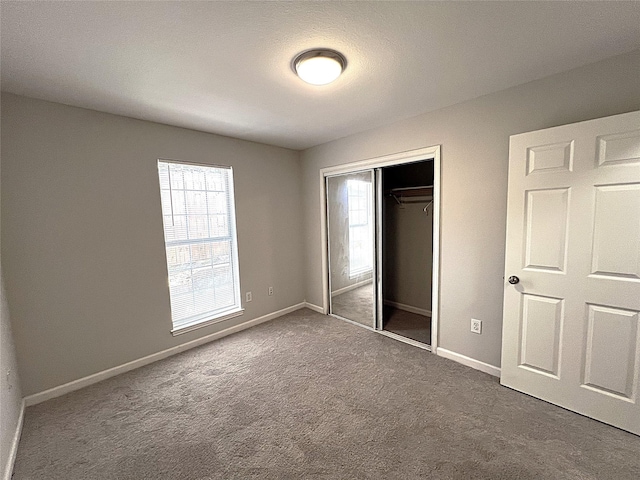 902 Mack Pl, Denton, TX 76209 - unfurnished bedroom with a closet, carpet, and baseboards
