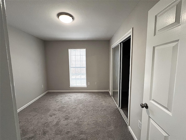 902 Mack Pl, Denton, TX 76209 - unfurnished bedroom with carpet floors, a closet, and baseboards