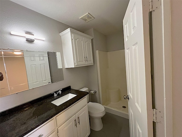 902 Mack Pl, Denton, TX 76209 - bathroom with a stall shower, toilet, vanity, and a textured ceiling