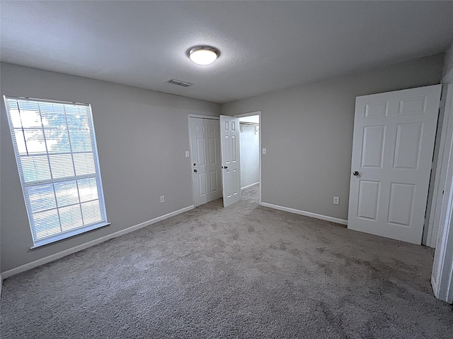 902 Mack Pl, Denton, TX 76209 - unfurnished bedroom with baseboards, carpet floors, and a closet