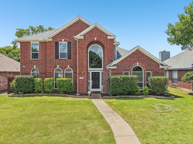 11003 Canoe Rd, Frisco, TX 75035 - traditional-style house with brick siding, a front lawn, and a shingled roof
