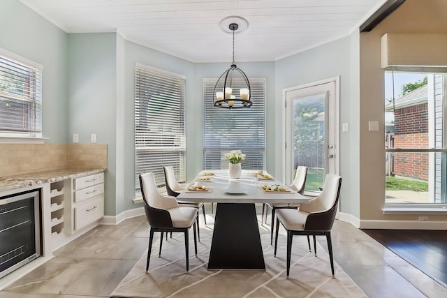 11003 Canoe Rd, Frisco, TX 75035 - dining area with ornamental molding, a chandelier, beverage cooler, and baseboards