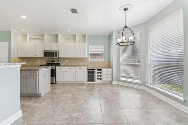 11003 Canoe Rd, Frisco, TX 75035 - kitchen featuring stainless steel appliances, wine cooler, a chandelier, tasteful backsplash, and recessed lighting