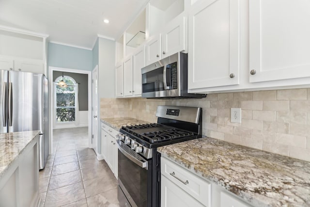 11003 Canoe Rd, Frisco, TX 75035 - kitchen with appliances with stainless steel finishes, white cabinets, light stone countertops, ornamental molding, and decorative backsplash