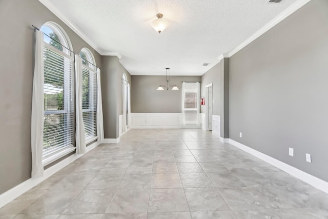 11003 Canoe Rd, Frisco, TX 75035 - unfurnished room featuring a chandelier, ornamental molding, a textured ceiling, and a decorative wall