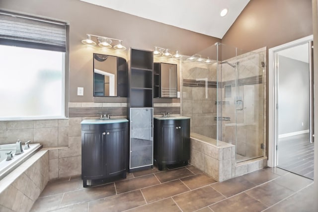 11003 Canoe Rd, Frisco, TX 75035 - bathroom with a stall shower, a garden tub, tile patterned flooring, two vanities, and tile walls