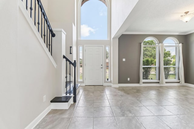 11003 Canoe Rd, Frisco, TX 75035 - foyer with stairway, baseboards, ornamental molding, and a textured ceiling