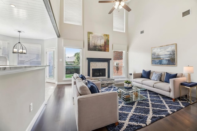 11003 Canoe Rd, Frisco, TX 75035 - living room with baseboards, plenty of natural light, dark wood-type flooring, ceiling fan, and a towering ceiling