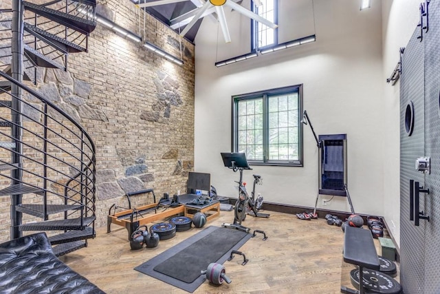 7212 John Mccain Rd, Colleyville, TX 76034 - exercise room with a towering ceiling, wood finished floors, and a ceiling fan