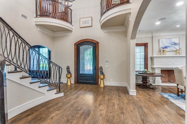 7212 John Mccain Rd, Colleyville, TX 76034 - entryway with wood finished floors, stairs, a high ceiling, baseboards, and arched walkways