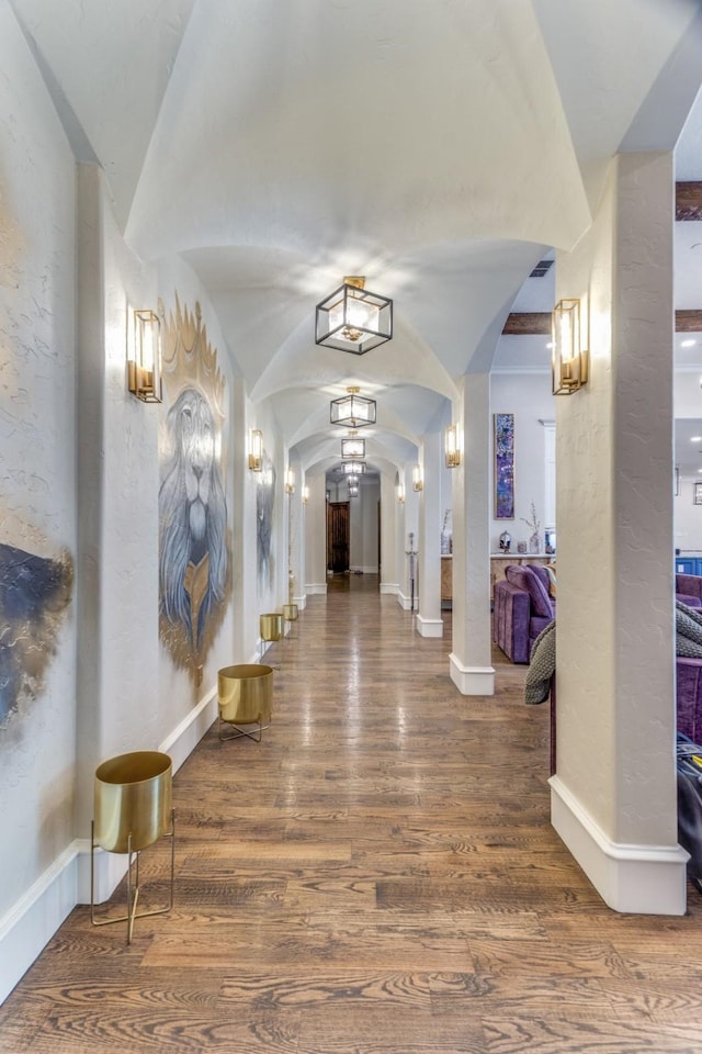 7212 John Mccain Rd, Colleyville, TX 76034 - hall featuring arched walkways, lofted ceiling, wood finished floors, a textured wall, and baseboards